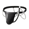 Black men's patent leather thong underwear with metal chain decoration on a grey background.