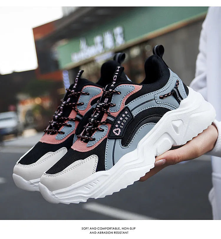 White women's casual mesh sports shoes with a thick sole, buckle detail, and round toe on a plain background.