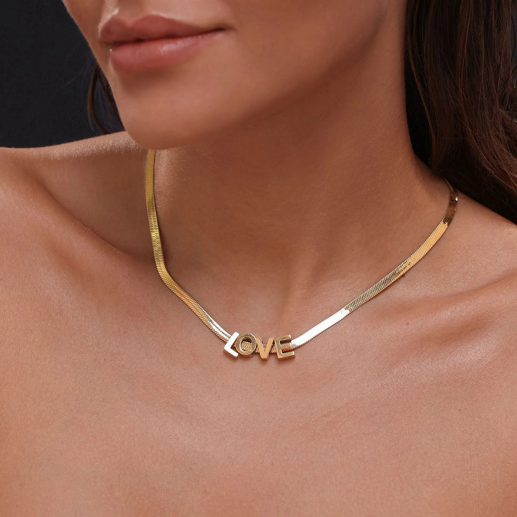 Gold titanium steel necklace with a letter A pendant on a blade chain.