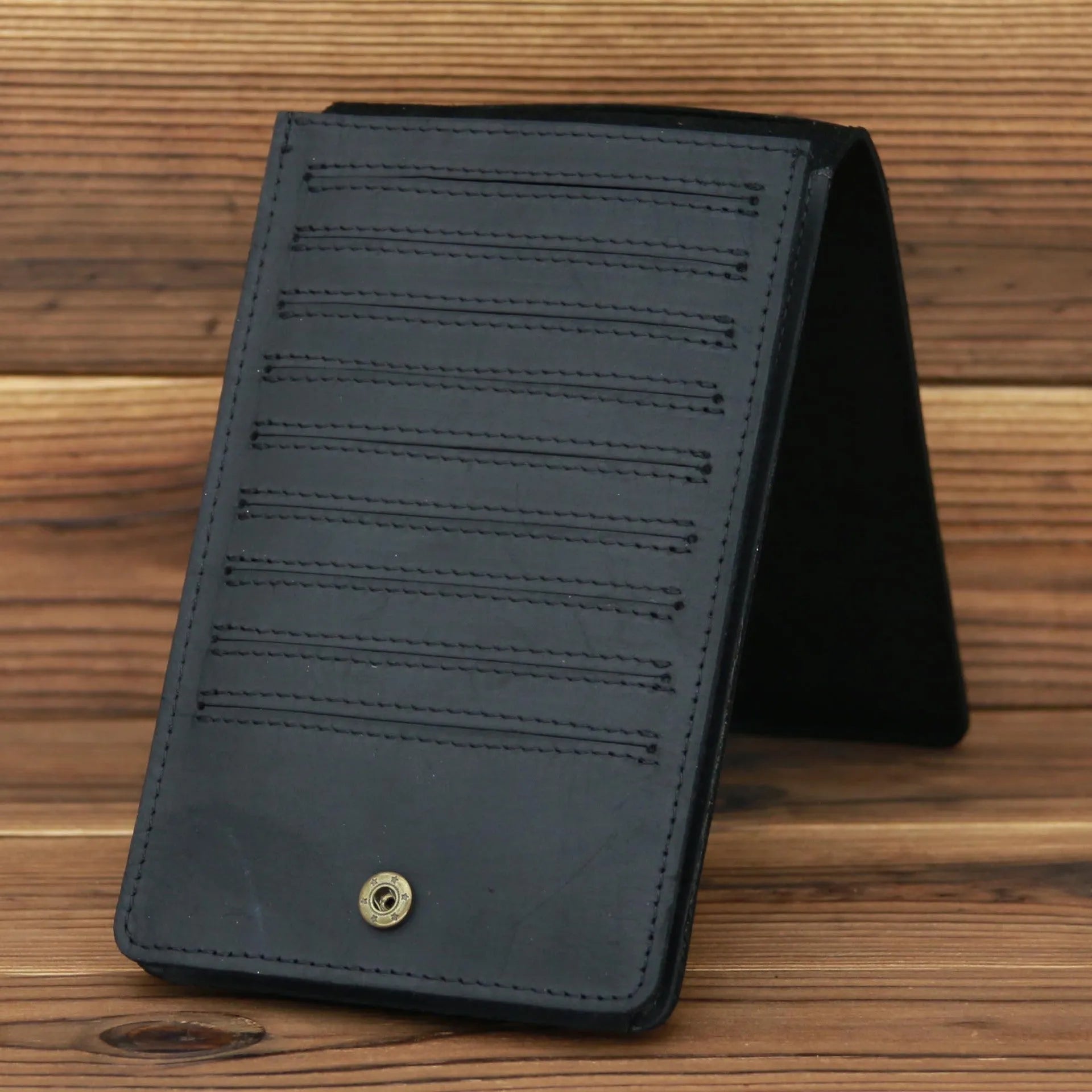Men's black cowhide leather card holder wallet open to show 18 card slots, money pocket, and phone pocket.