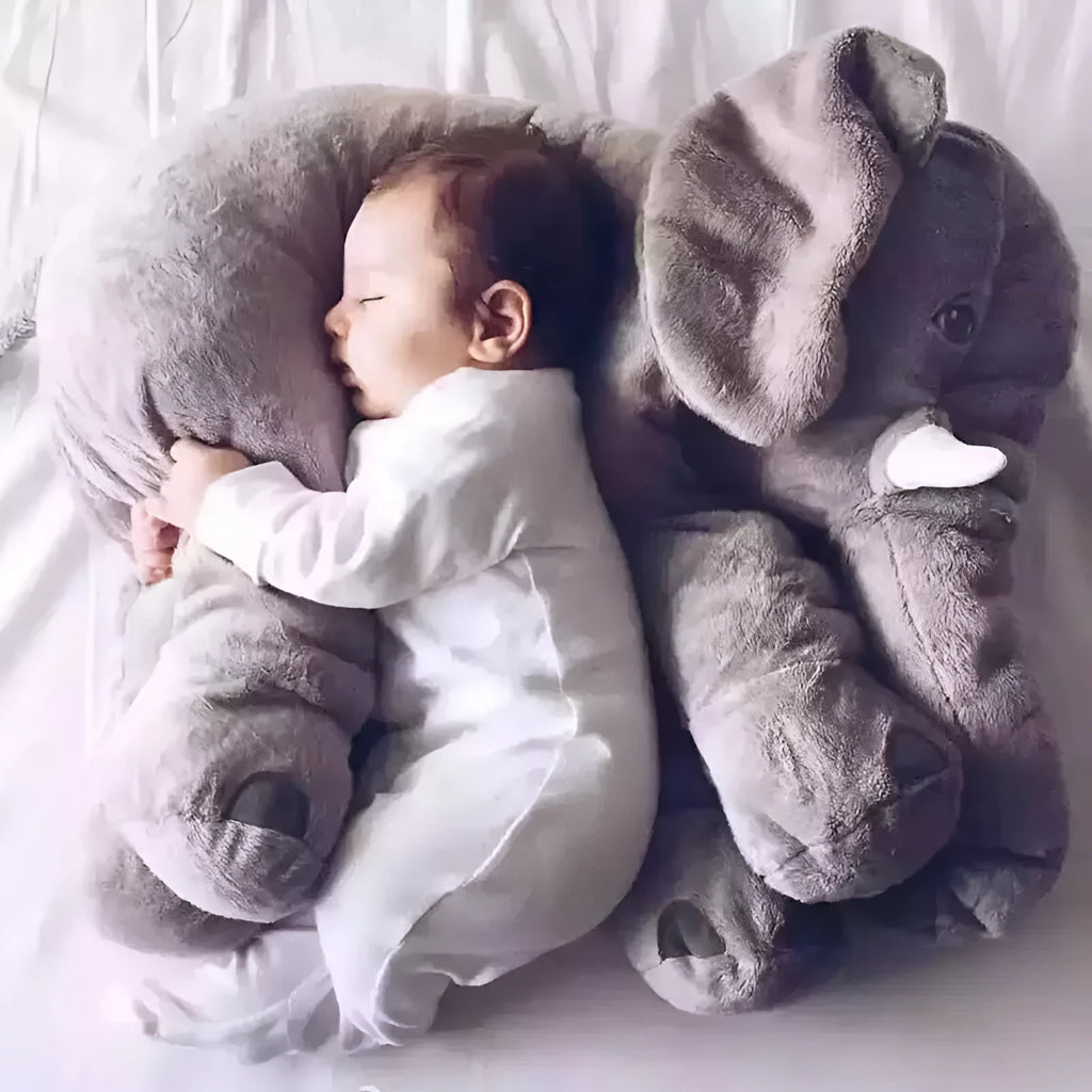 Grey elephant-shaped plush pillow cover for a child's bed, shown alongside blue and pink versions.