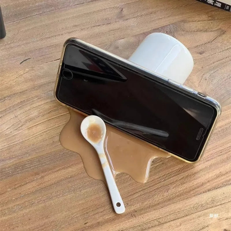 Overturned coffee decoration toy phone holder in macchiato colour on desk with plastic stent