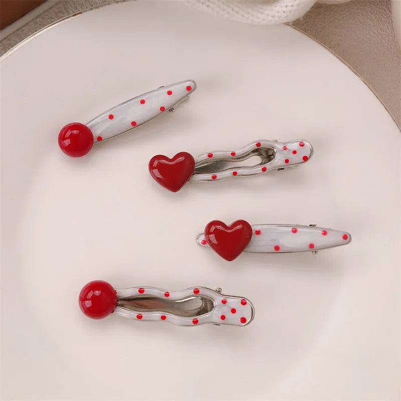 Red love heart shaped hair clip with dotted patterns and willow leaf designs on a barrette