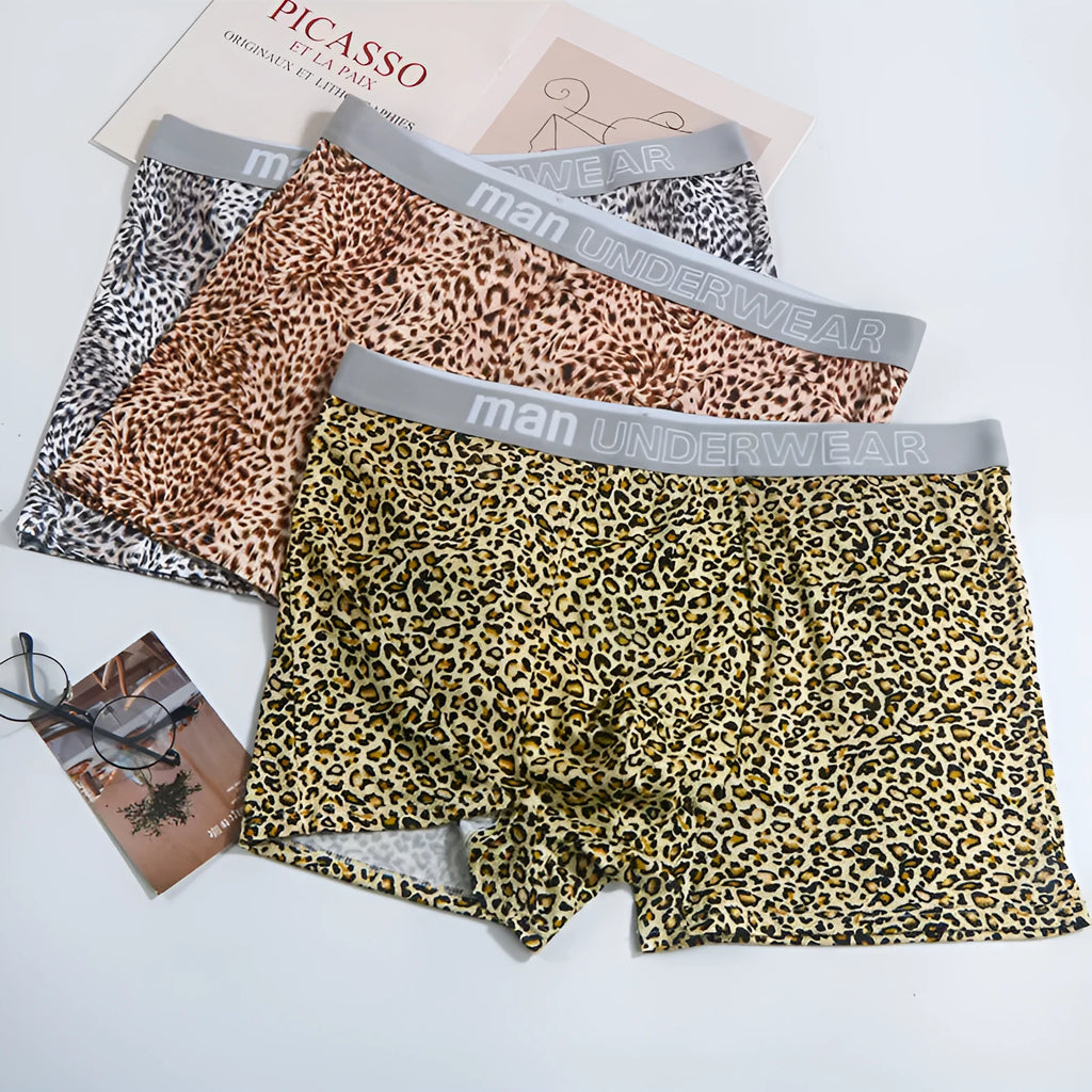 Men's loose fit leopard print boxer shorts showing mid-waist design and polyester knit fabric texture
