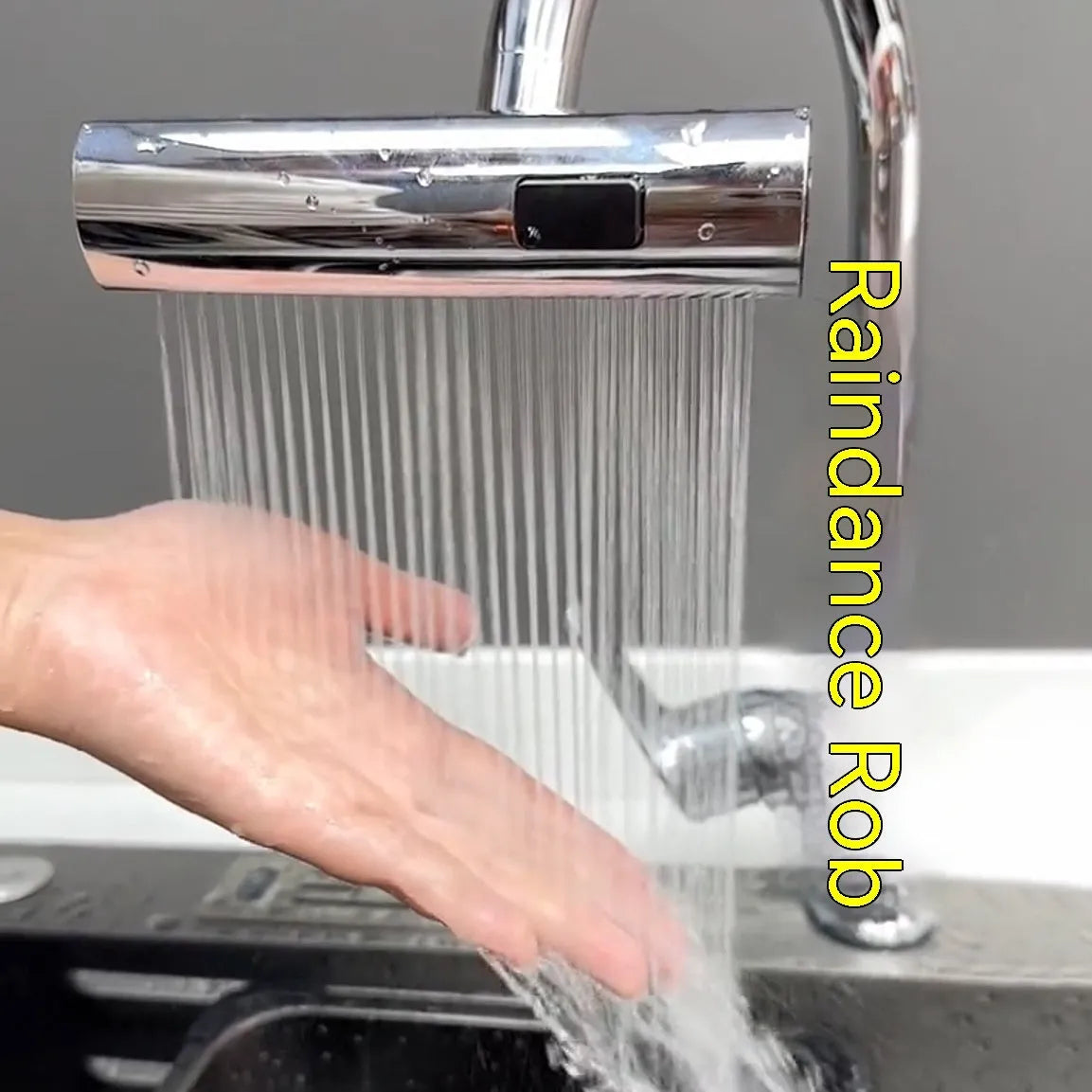 Brushed nickel kitchen faucet connector with pull-down sprayer, showing waterfall water flow mode.