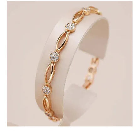 Golden copper hollow carved U-shaped bracelet for women on a plain background.