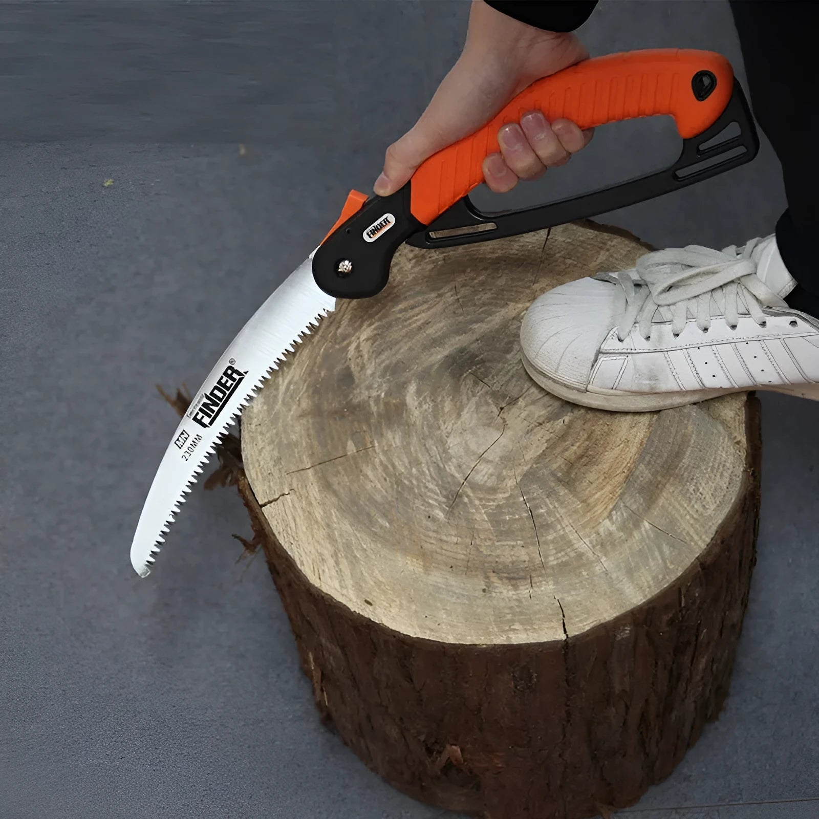 A folded garden hand saw with a TPR handle and a 230mm long metal saw blade extended.