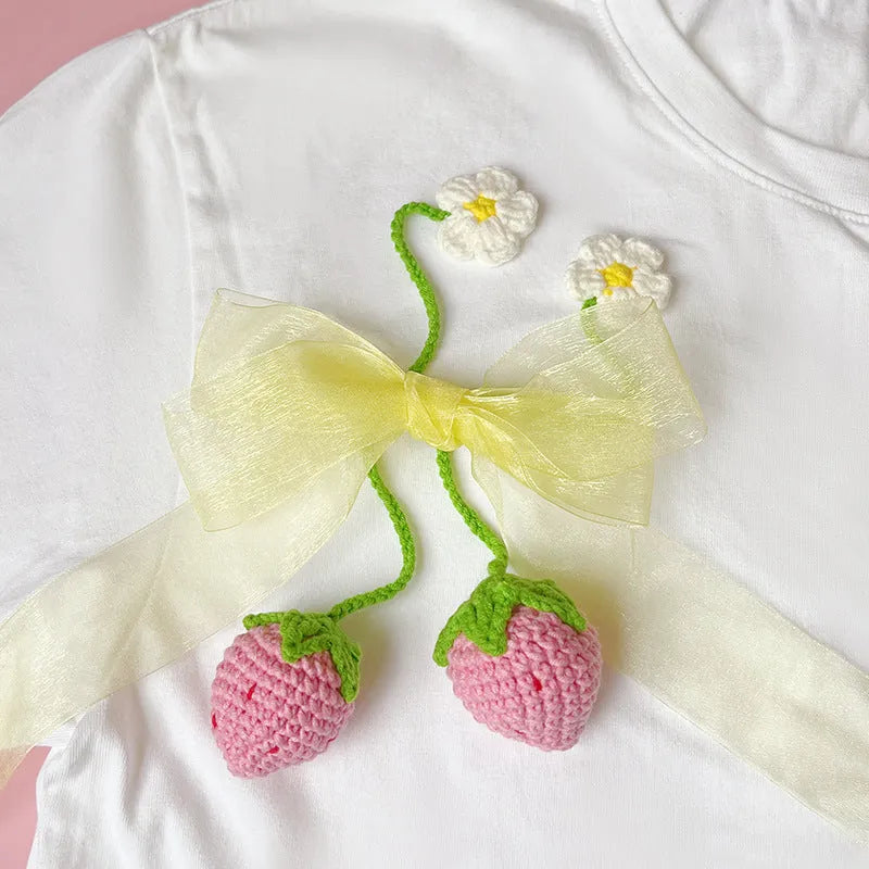 Wool crochet strawberry pendant necklace in pink colour with textured knitting details