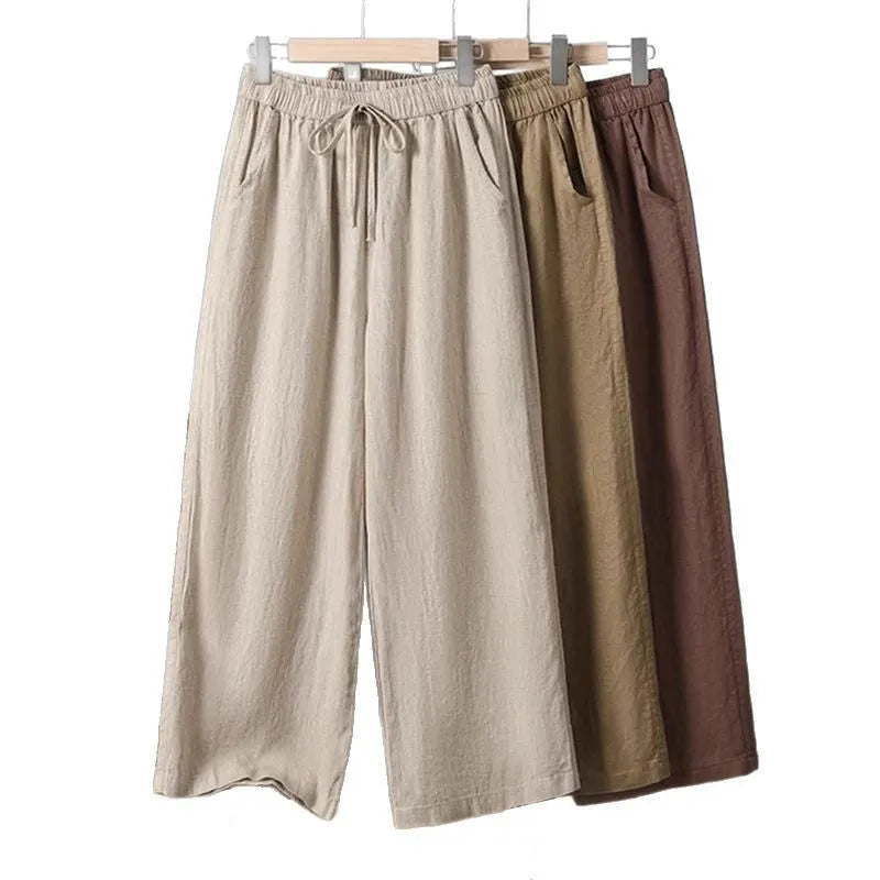 Women's straight leg casual trousers in apricot colour with an elastic waistband and lace-up drawstring detail.