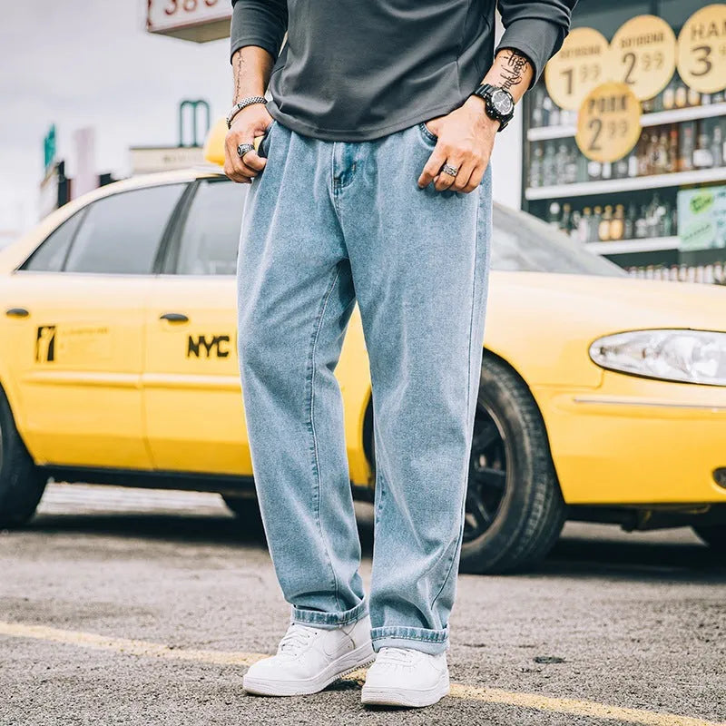 Men's loose straight-cut cotton jeans in dark blue, shown in a casual setting