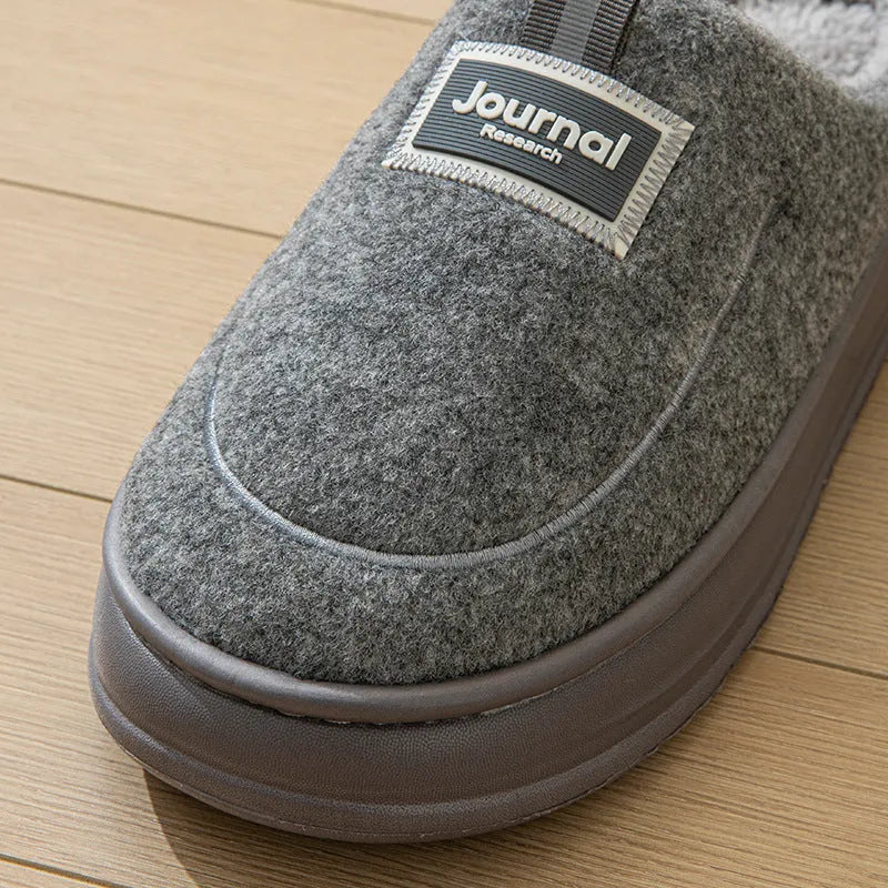 Men's brown thickened cotton slippers with a suede upper and textured sole, shown from the side.