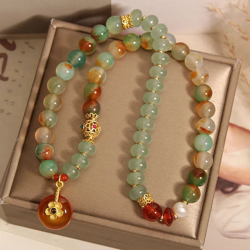 Peacock green agate double ring bracelet for women with safety buckle clasp and rhinestone details.