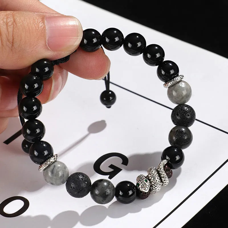 A matching couple bracelet set: one black agate and one white agate bracelet with snake chain clasps.