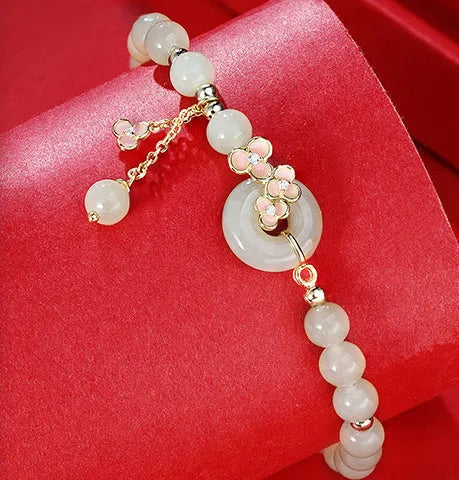Peach blossom Hetian jade bracelet and necklace set with floral beads in sterling silver mounting