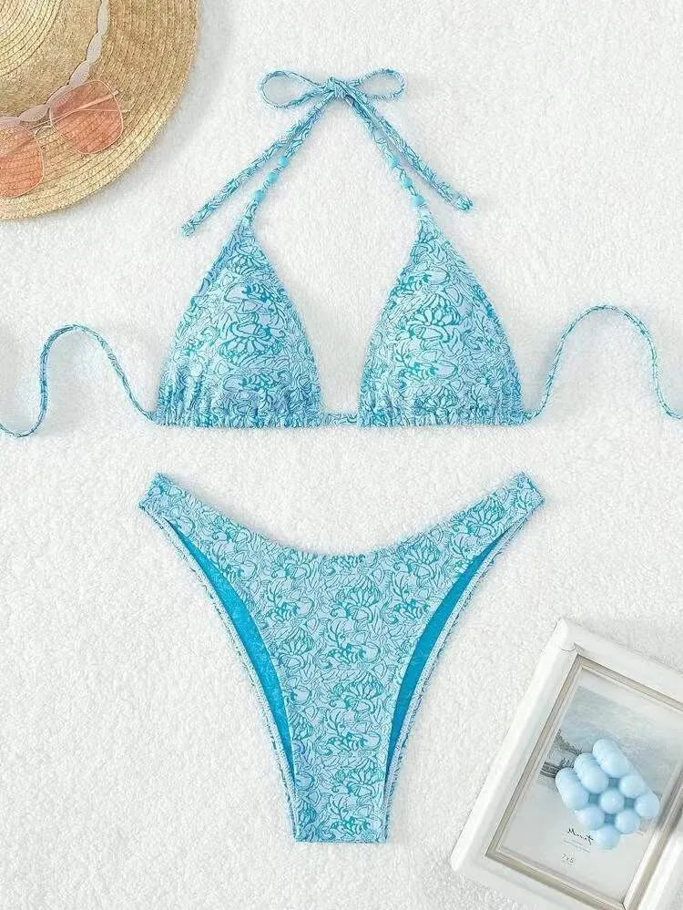 Women's floral pattern halter lanyard bikini set in emerald green, shown with top and shorts.