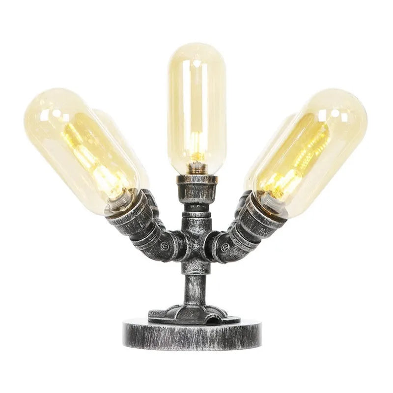 Retro iron art water pipe desk lamp with silver ancient finish on a wooden desk