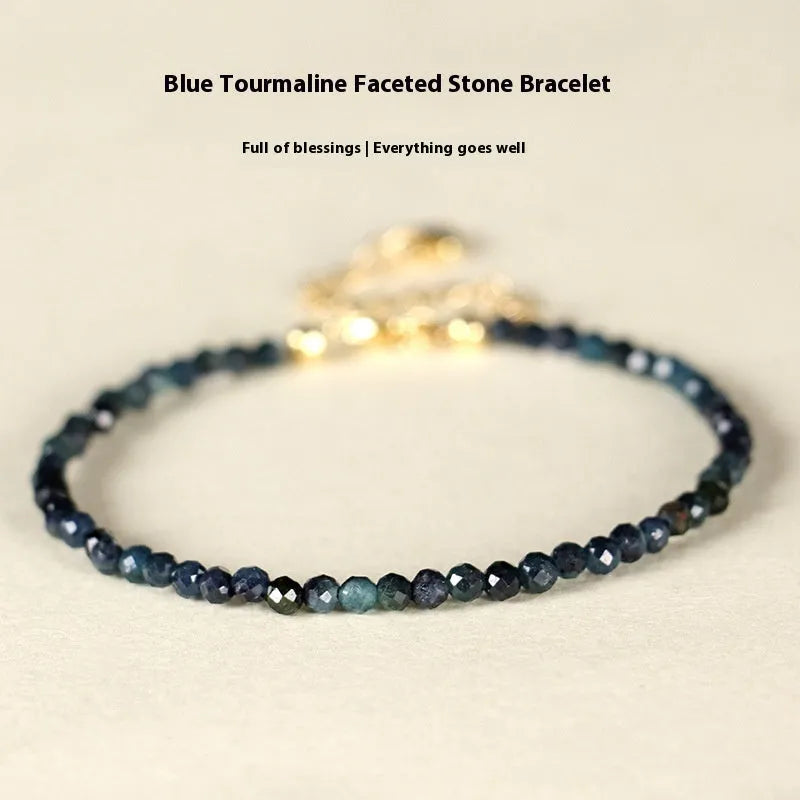 Blue tourmaline beaded bracelet with spacer beads on wrist showing 3mm gemstone size