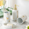White ceramic bathroom wash kit with two cups, latex bottle and soap box in packaging