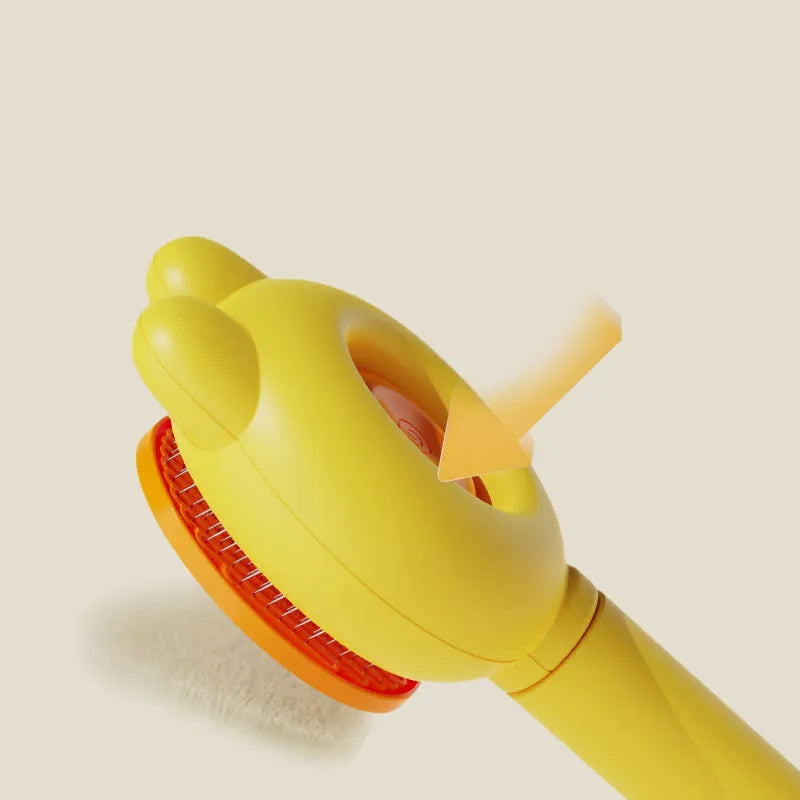 Self-cleaning pet brush with coloured comfort-grip handle and metal comb, shown with release button activated.