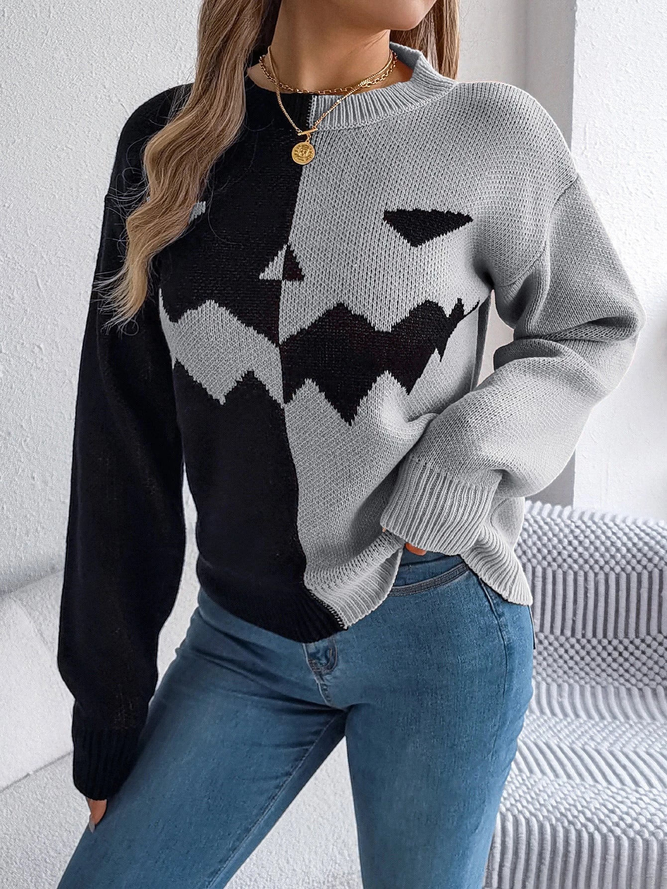 A cozy, acrylic Halloween pullover sweater with a ghostly design in autumnal colors