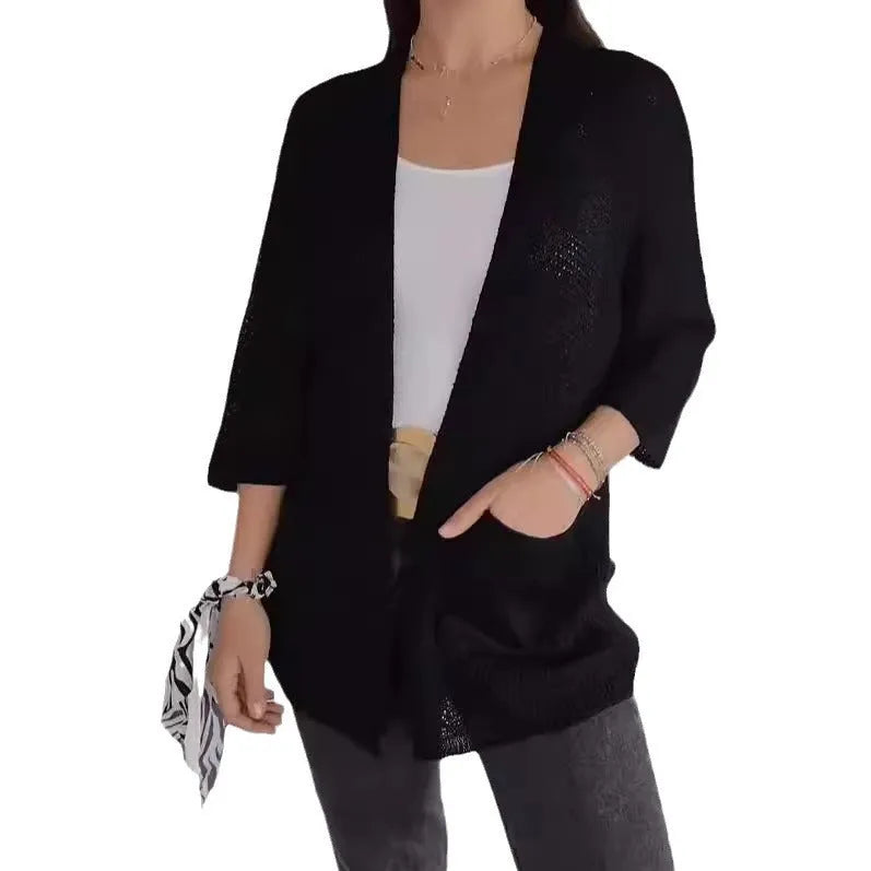 Women's waffle-knit cardigan coat in army green, showing texture and pocket detail.