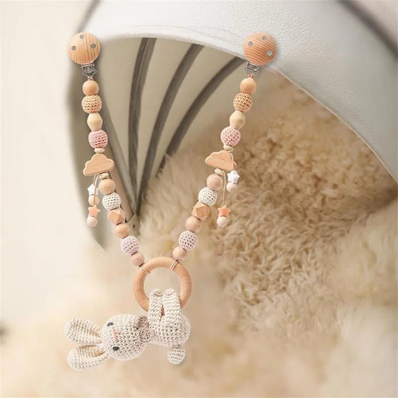 Baby crib hanging bunny music toy with metal construction in cart chain rabbit colour, showing biteable pendant for infant soothing and development.
