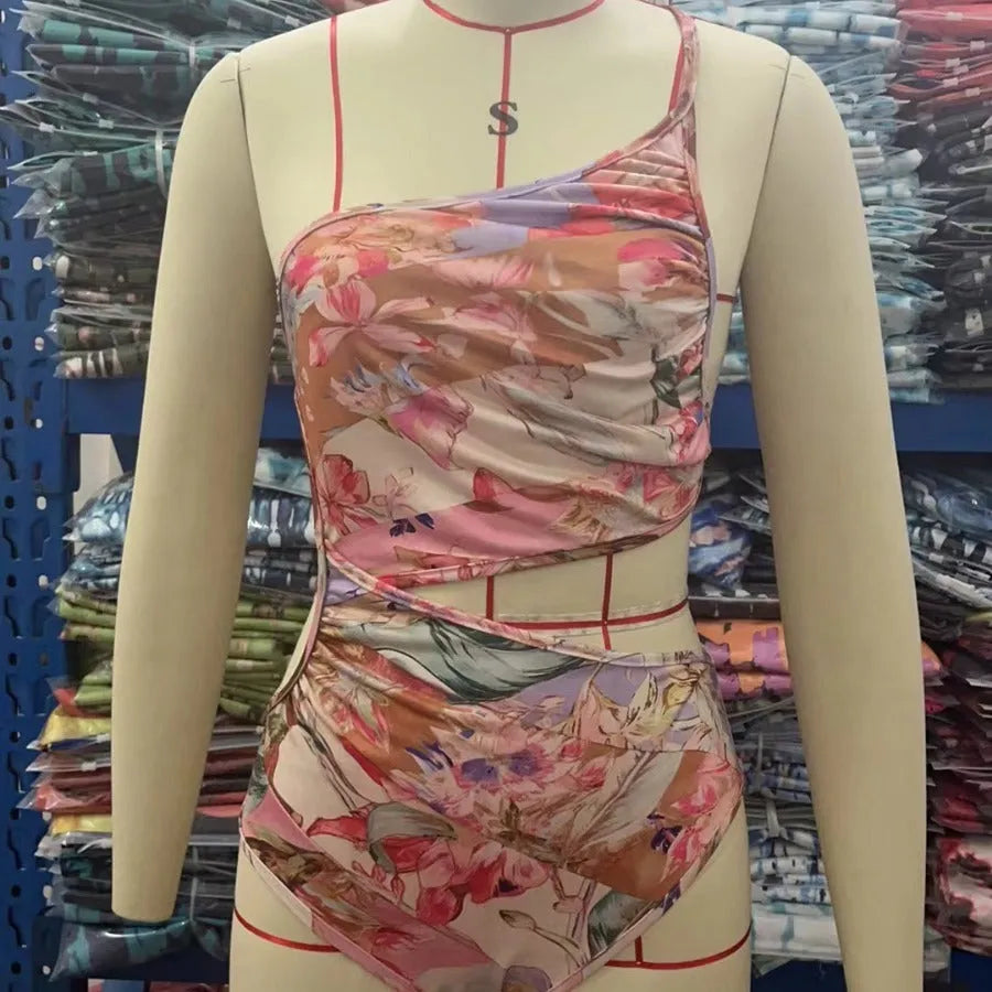 Rose gold patterned women's one-piece swimsuit on a hanger.