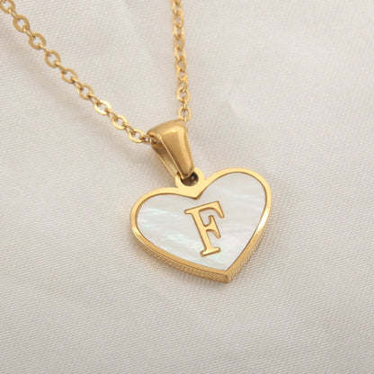 A personalized heart-shaped necklace with a 26-letter charm, crafted from high-quality stainless steel and gold plating.