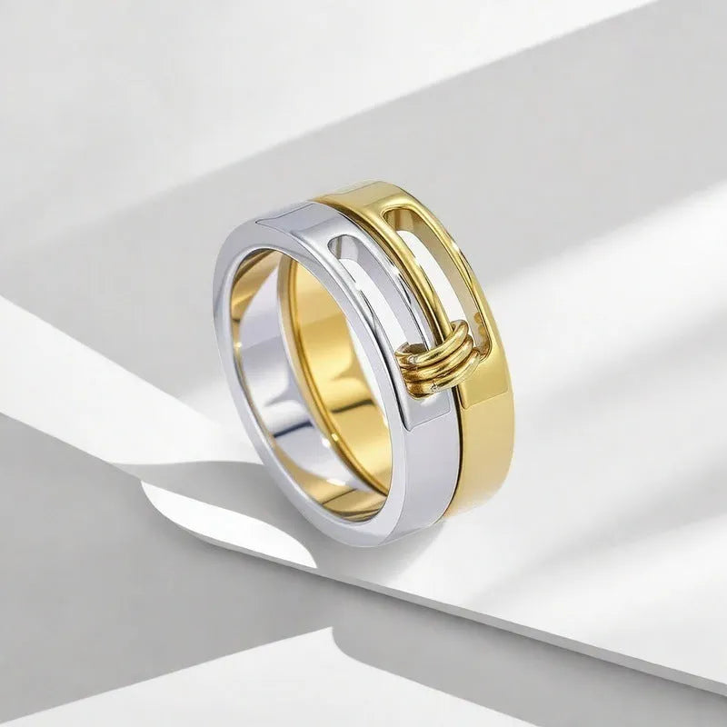 Gold double-layer twin ring made of titanium steel on a plain background