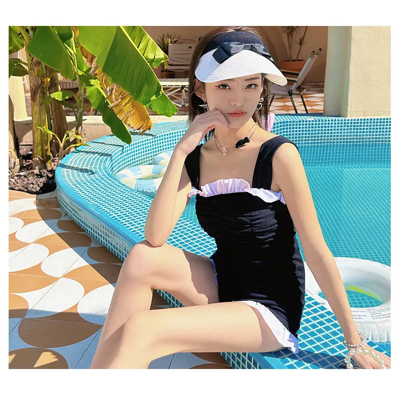 Women's black suspender-style one-piece swimsuit in polyester fabric