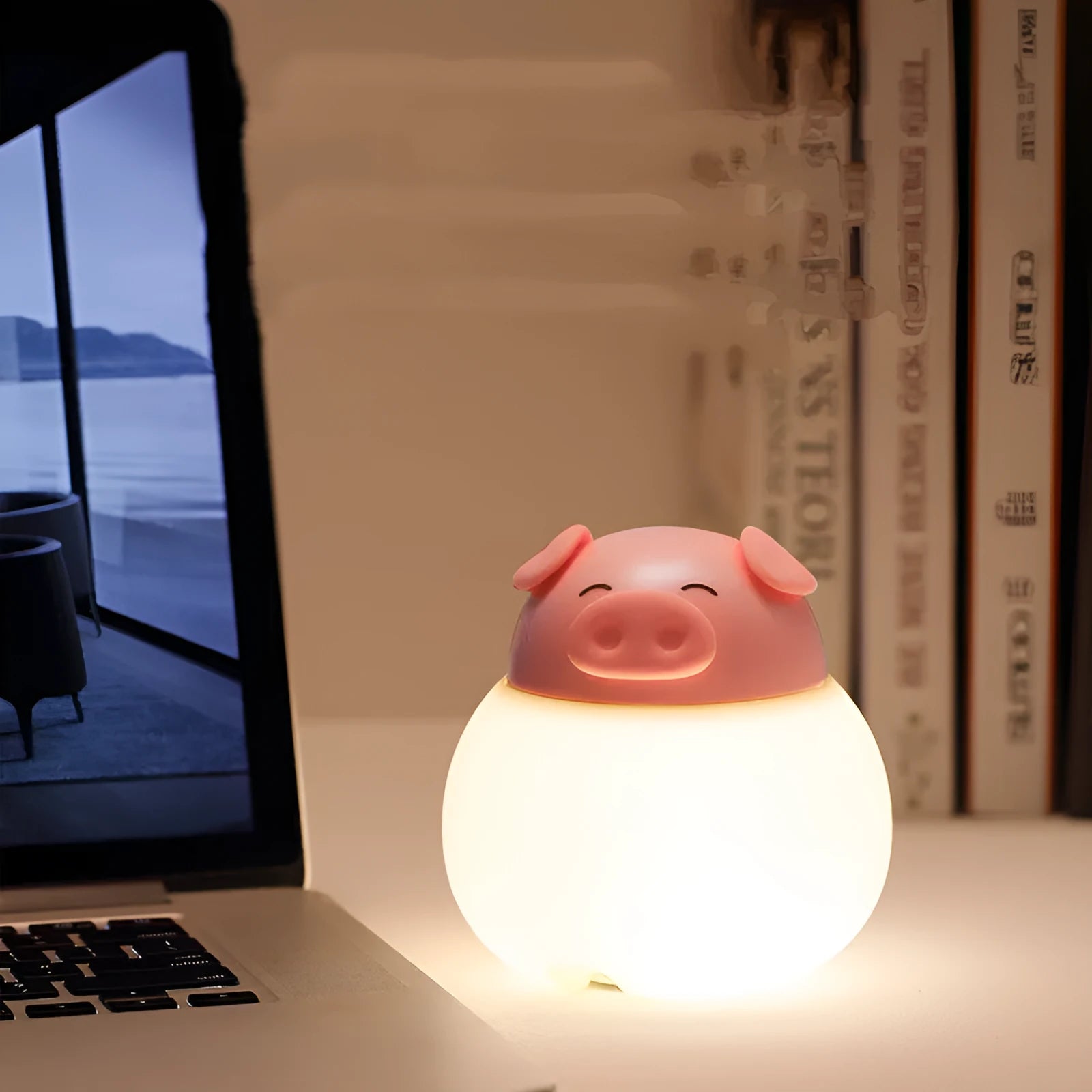 Pink pig silicone pat bedside lamp with USB LED light source on a table