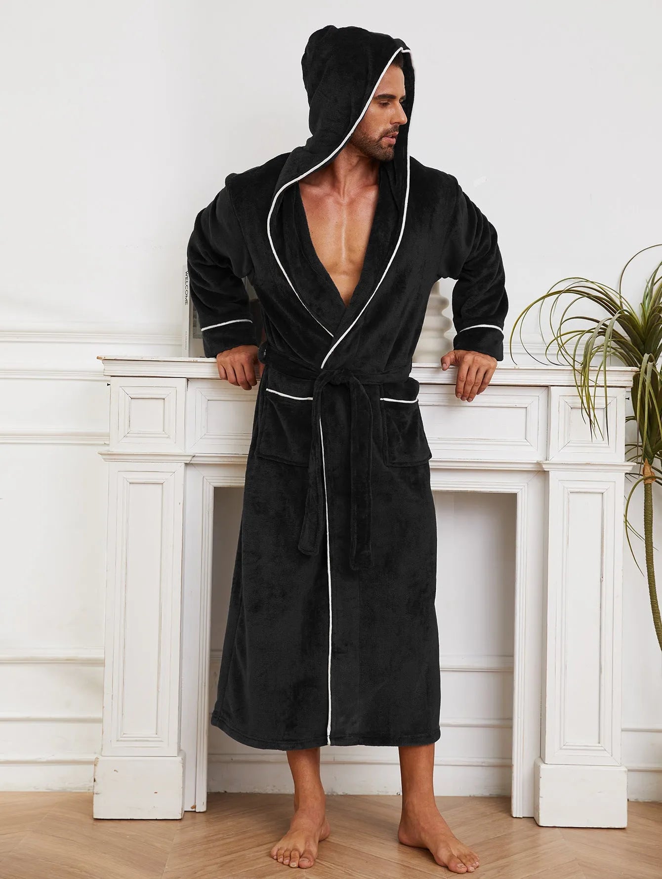 Man wearing a light grey flannel-style bathrobe at home, showing the front wrap design and soft texture.