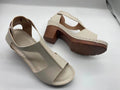 Women's beige peep toe wedge sandals with a buckle strap and low heel