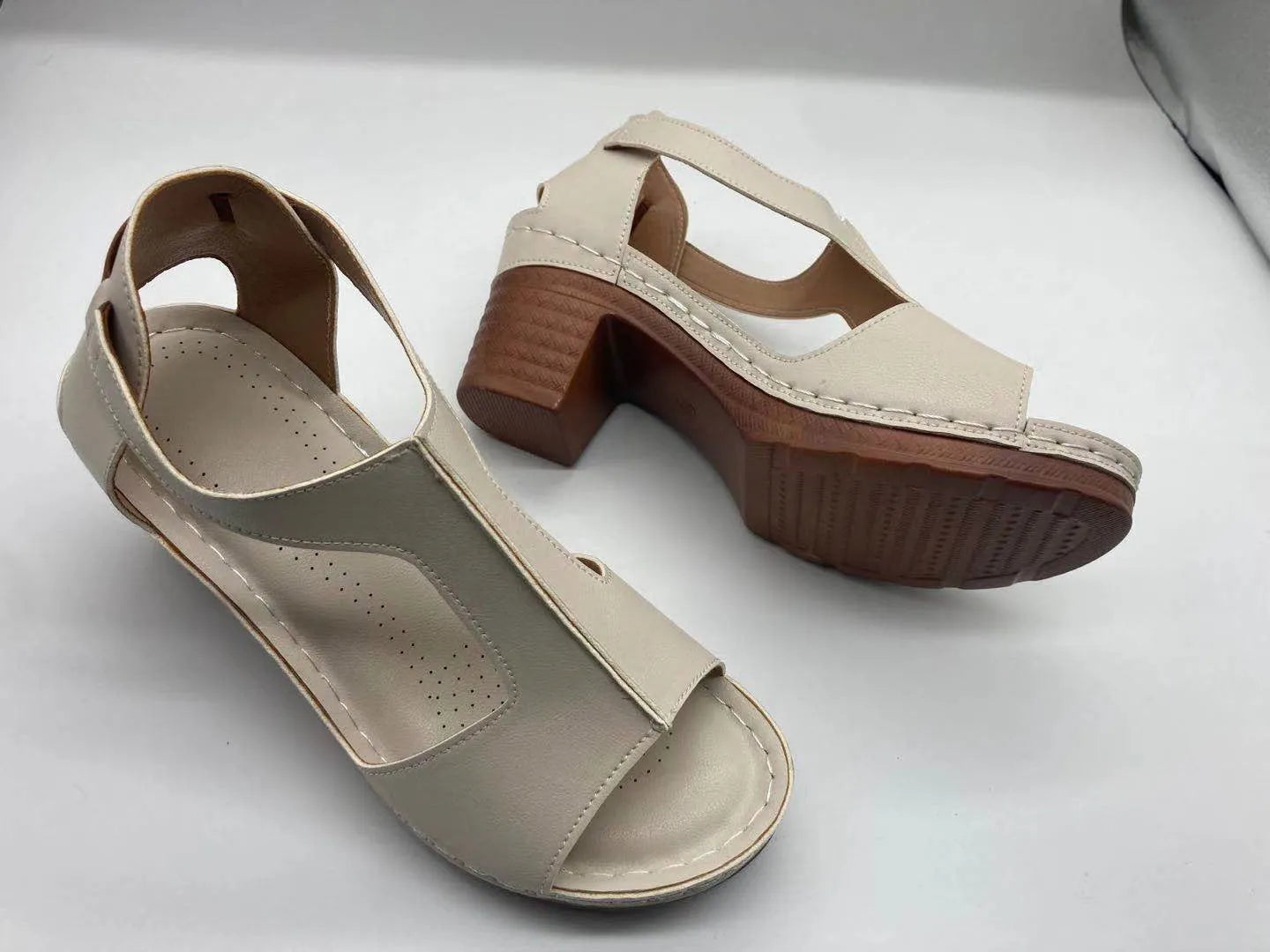 Women's beige peep toe wedge sandals with a buckle strap and low heel
