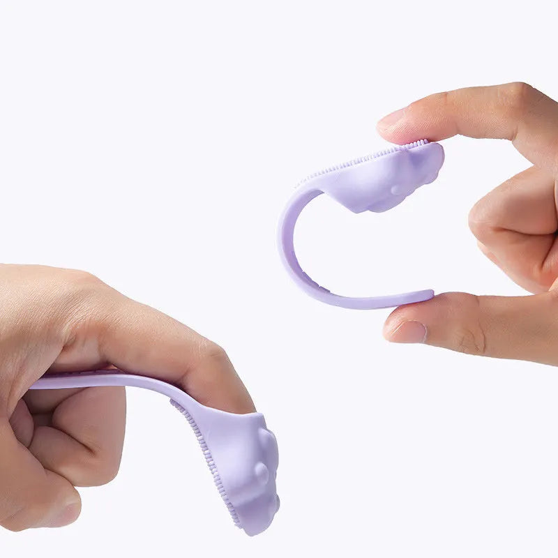 Silicone fingertip toothbrush for pets in pink, purple, and yellow, shown on a finger.