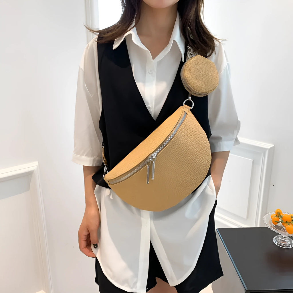 Solid colour women's crossbody bag with saddle lock zipper texture in a horizontal square clamshell shape.