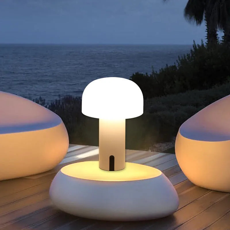 Decorative LED mushroom night light in green with touch switch and USB charging cable on bedside table