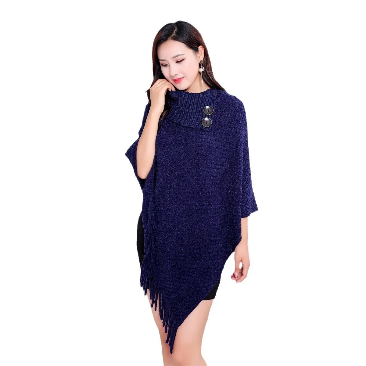 Sleeveless knitted cloak shawl with dot pattern, shown in apricot colour