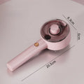 Pink and white cat grooming steam brush with mist function, rounded head, and stainless steel bristles.