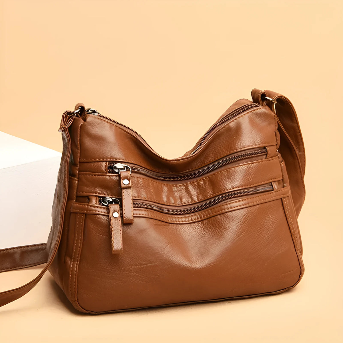 Real washed leather crossbody bag in solid colour with soft handle and slit pocket