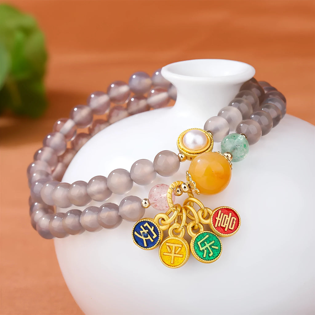 Close-up of a natural grey agate two-circle bracelet with retro design on a wrist.