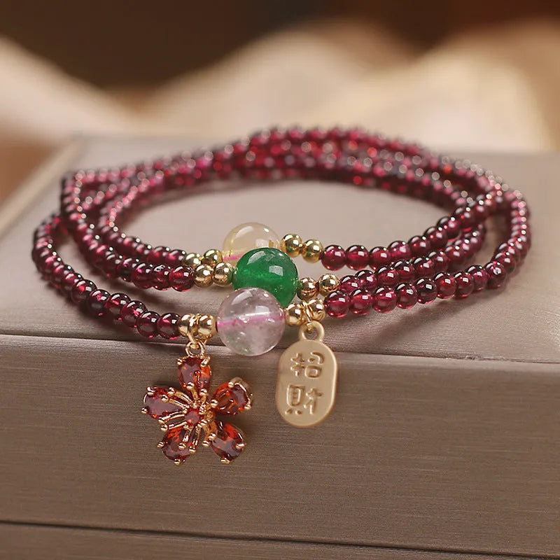Crystal bracelet for women in pomegranate red cherry blossom colour with sequin details.