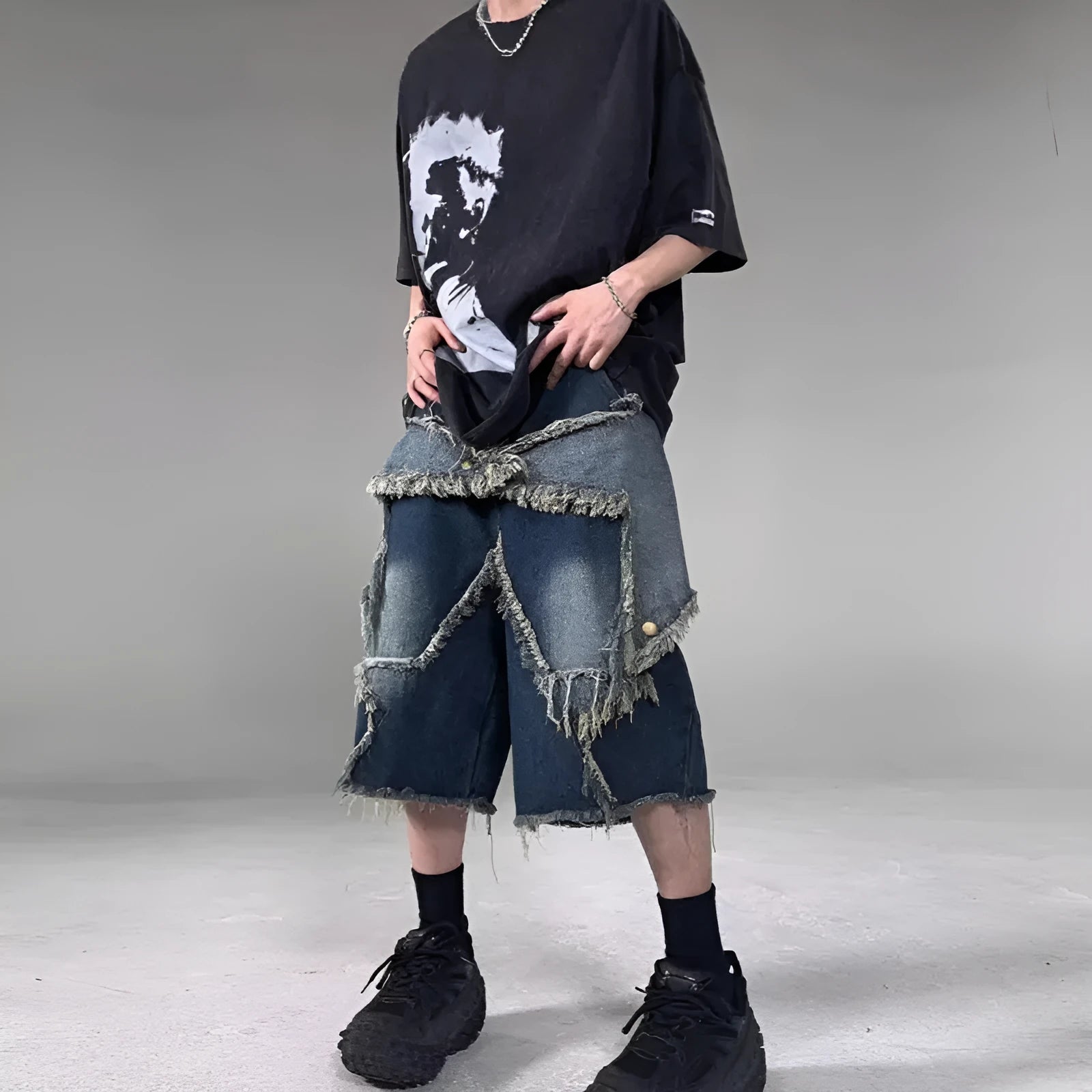 Blue denim shorts with frayed detailing and five-pointed star design in loose fit style