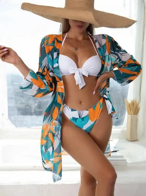 Women's three-piece bikini swimsuit set with mesh panels and matching beach coat in a colour option.