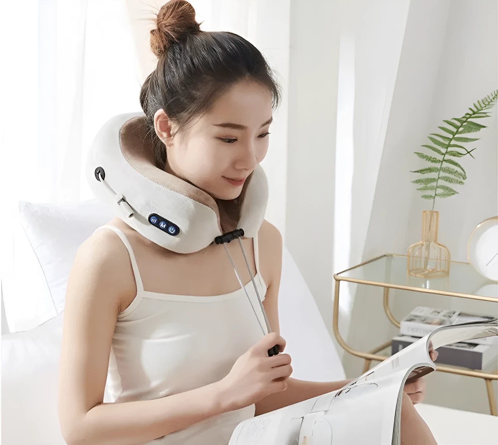 Brown U-shaped electric neck massage pillow on a grey background.