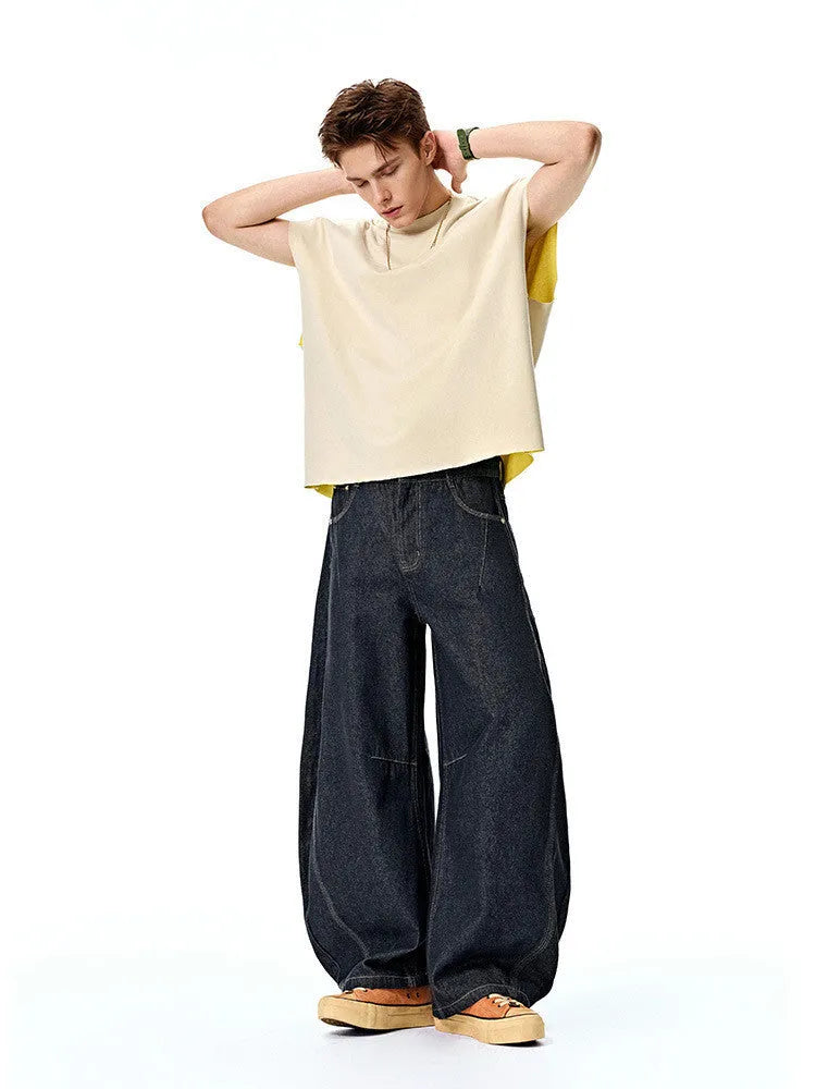 Men's wide leg denim trousers in original cow colour, showing mid-waist and relaxed fit.