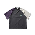 Dark grey loose fit t-shirt with light coloured raglan sleeves on a hanger