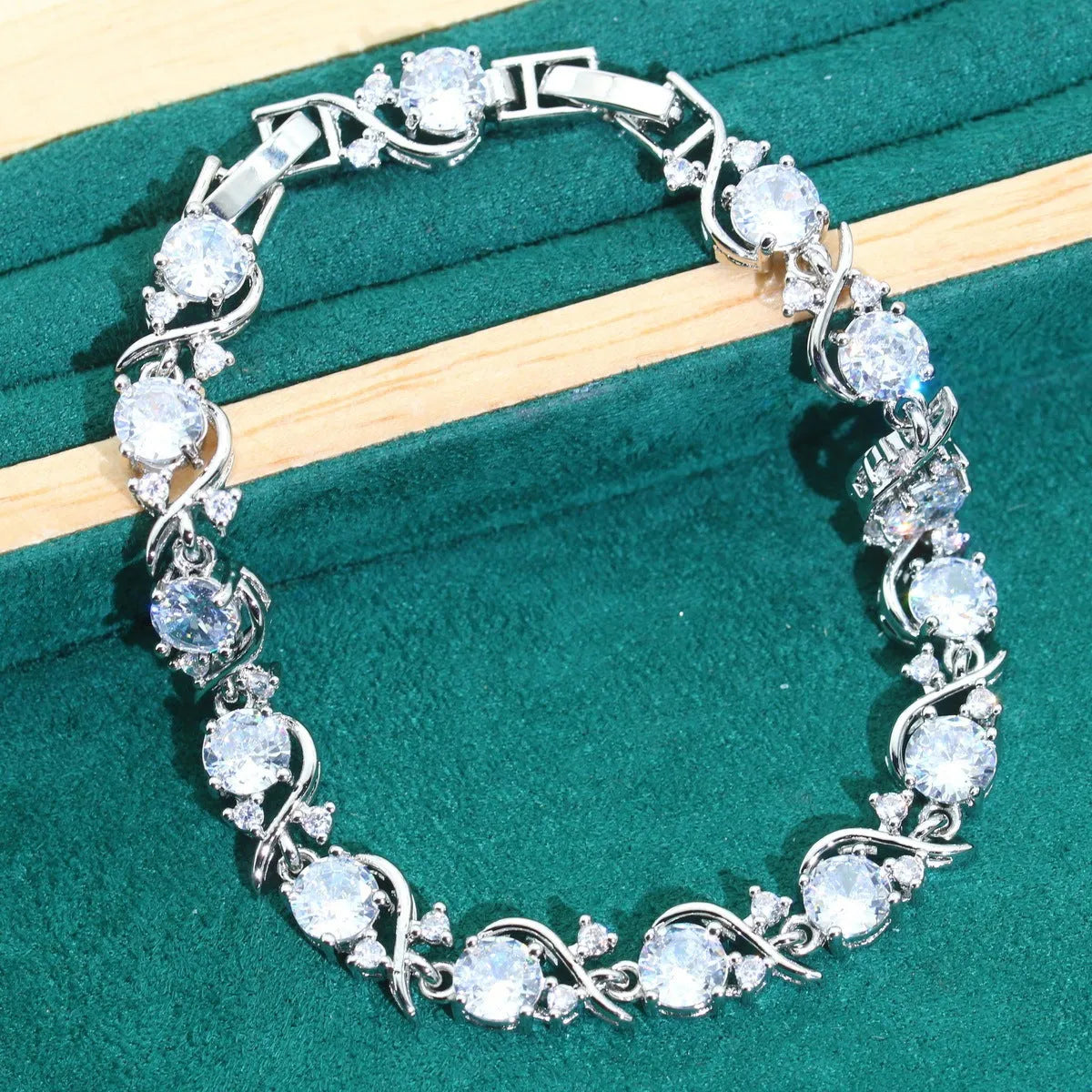Zircon bridal jewellery four-piece set showing necklace, earrings, bracelet, and ring with alloy pendant