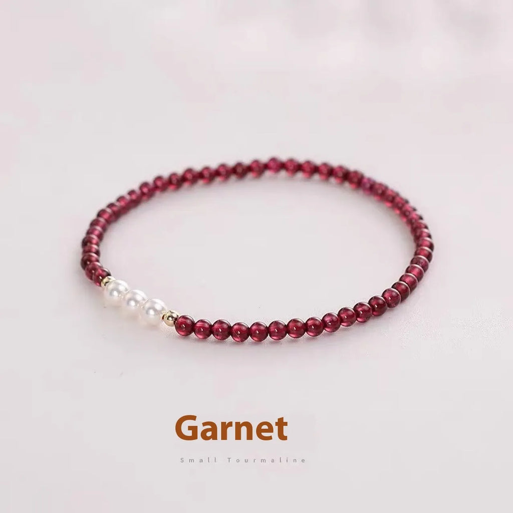 Women's artificial pearl bracelet with Chinese garnet beads in crystal construction
