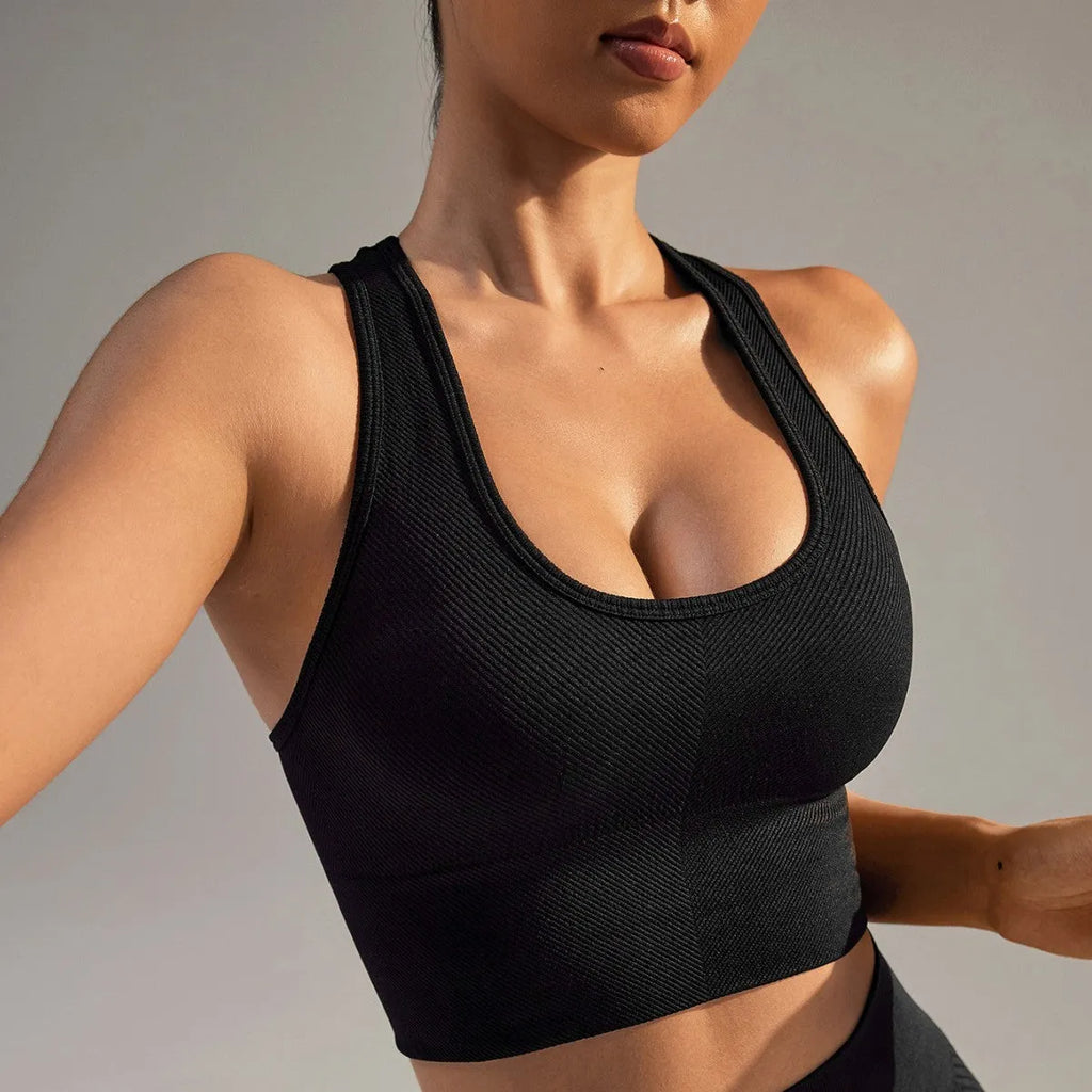 Black cross-back sports bra with moulded cups and fixed double straps on a mannequin